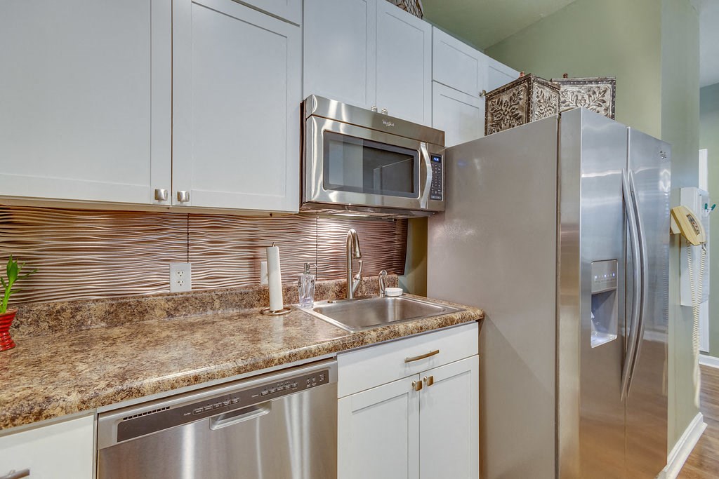 a kitchen with stainless steel appliances and a counter top