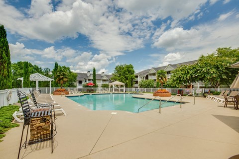 our apartments have a swimming pool with chairs and tables