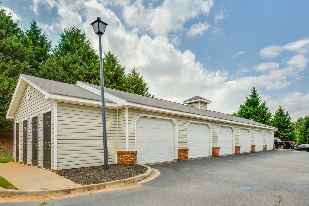 a white garage with a lamp post in front of it