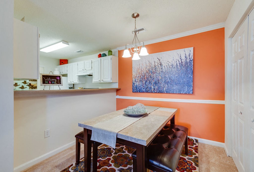 a dining room with a table and chairs and a kitchen