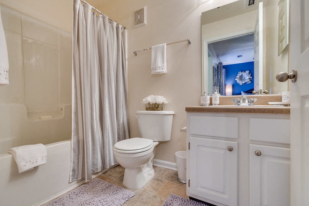 a bathroom with a toilet and a shower and a sink