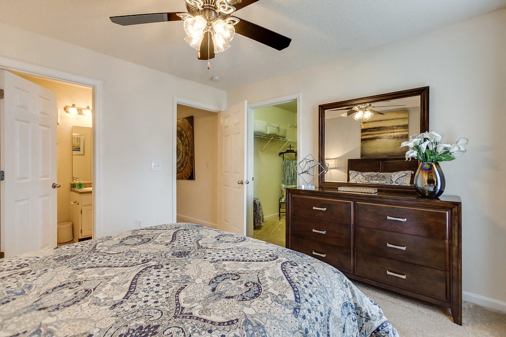 a bedroom with a bed and a ceiling fan