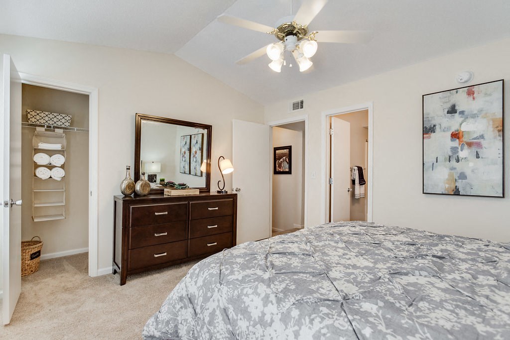 a bedroom with a bed and a ceiling fan