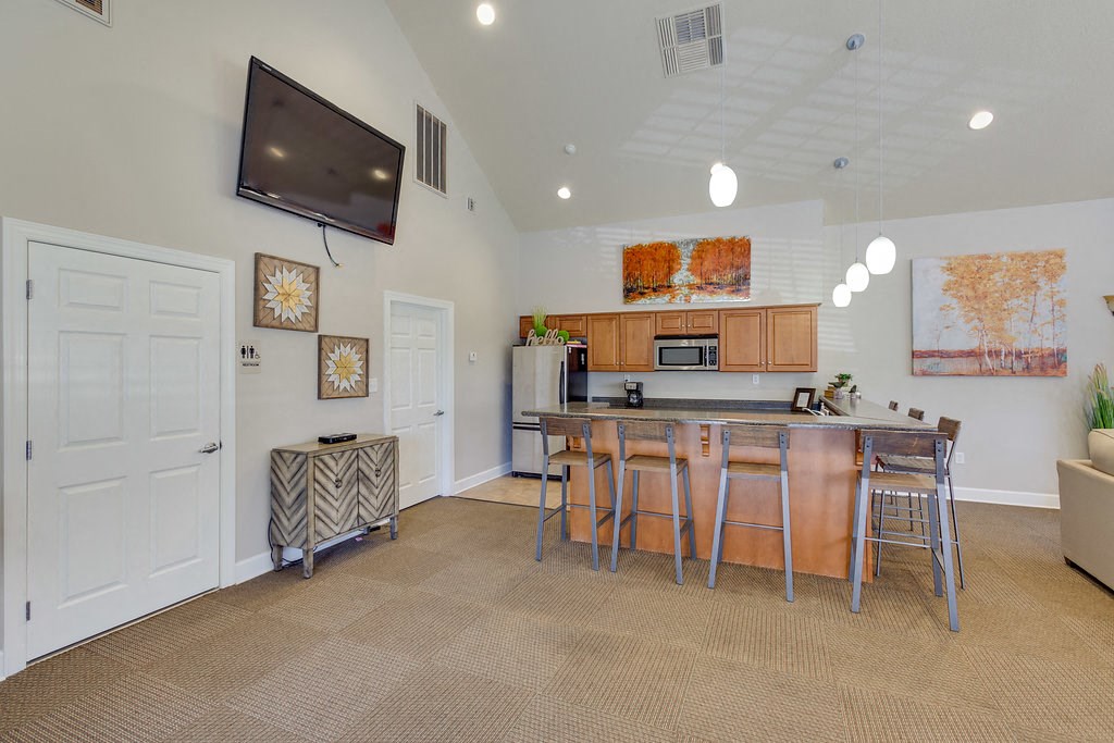 a kitchen with a bar and a counter with stools