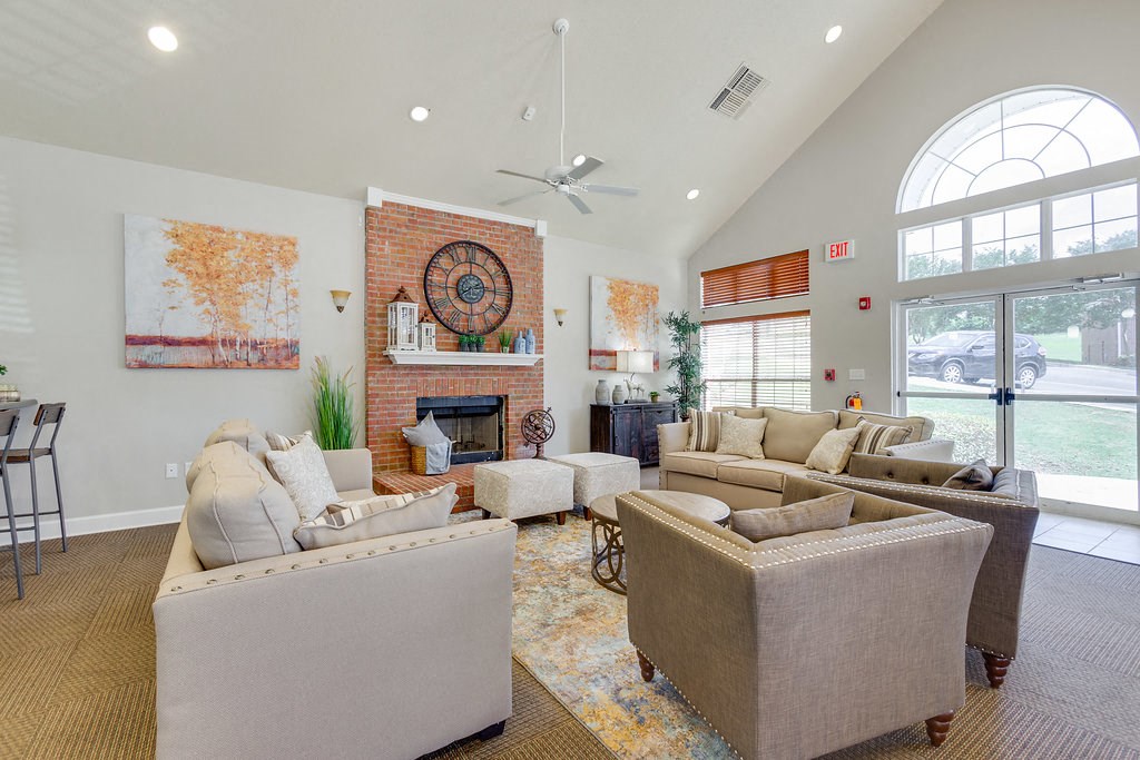 a living room with couches and chairs and a fireplace