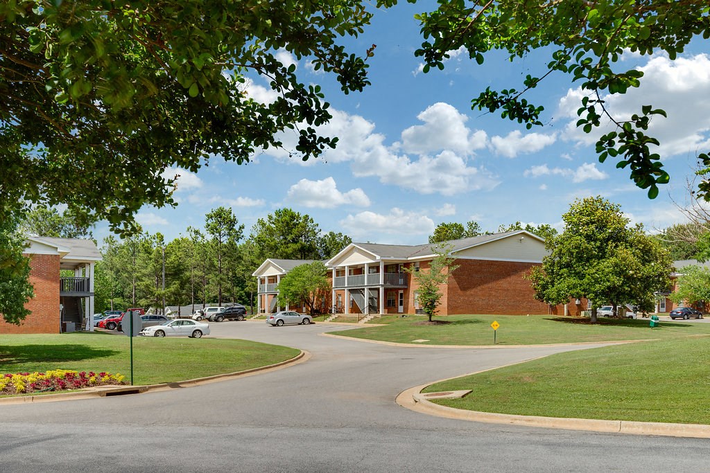 a street view of a building with cars parked in front of it