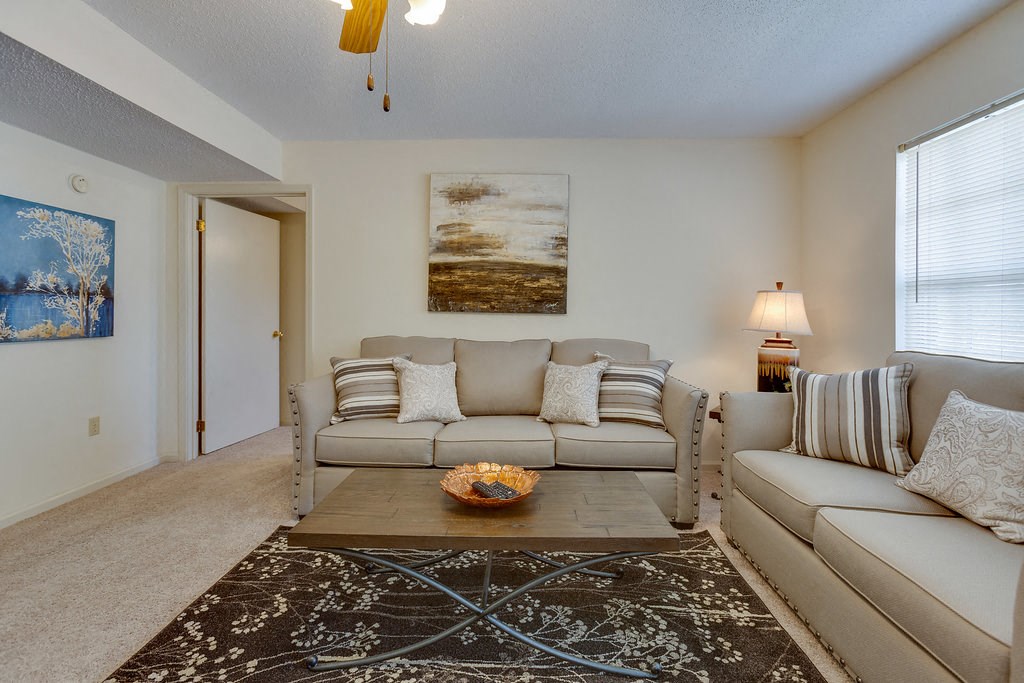 a living room with couches and a coffee table