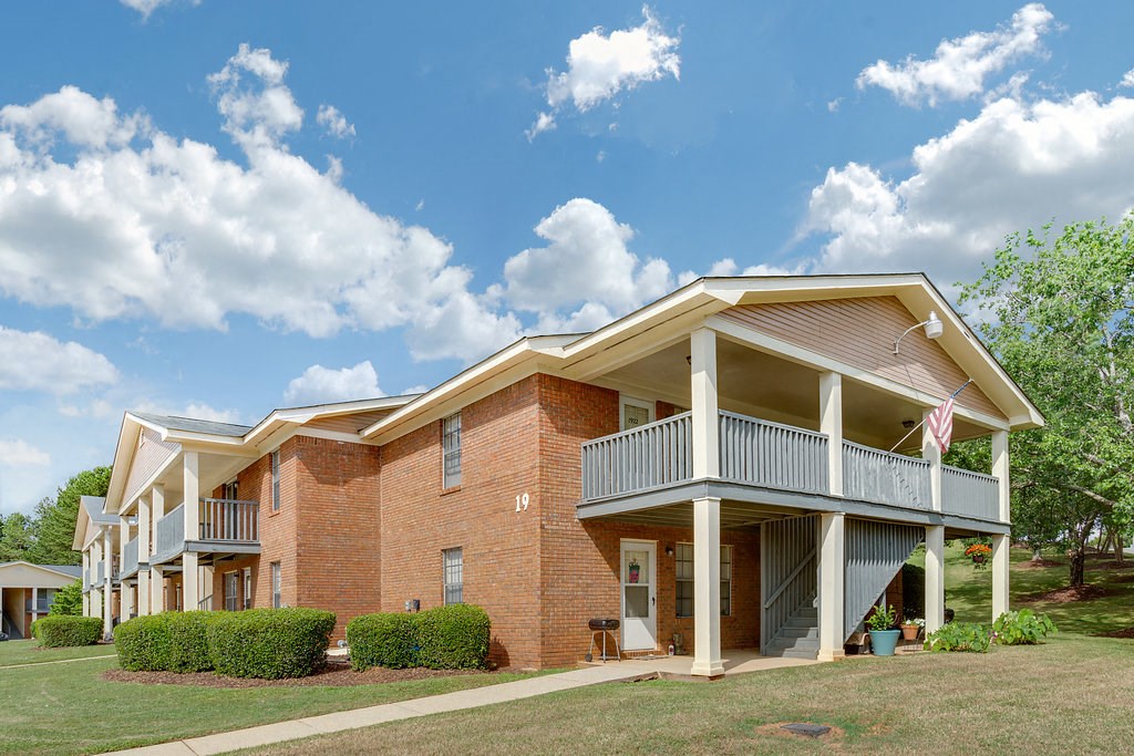 the outlook of a building with a porch and a balcony