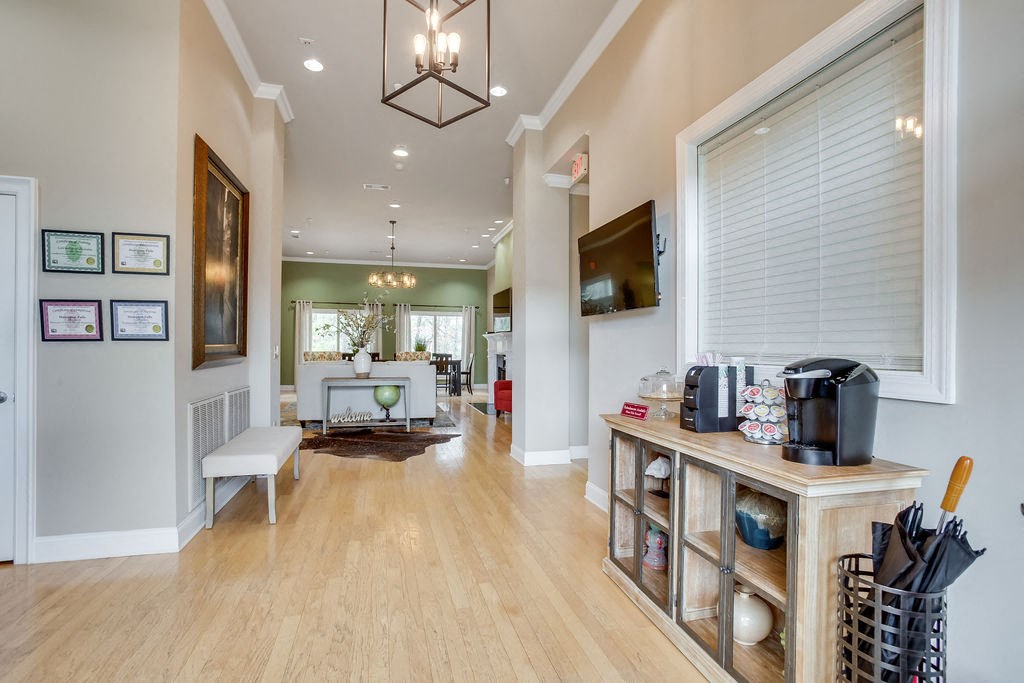 a living room with a large window and a wooden floor