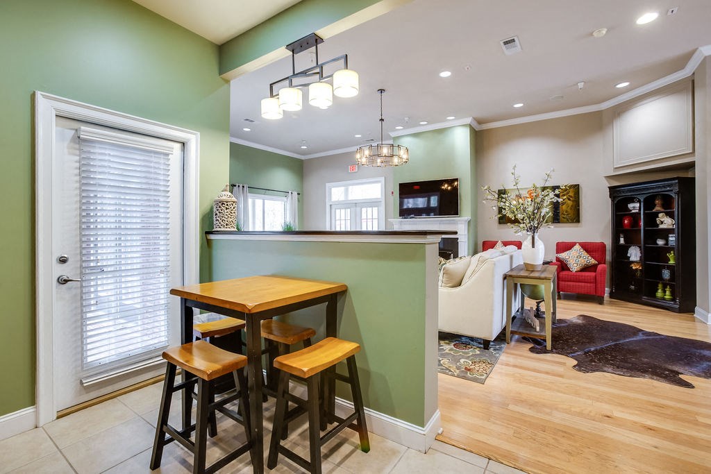 a kitchen with a bar and a living room with a couch