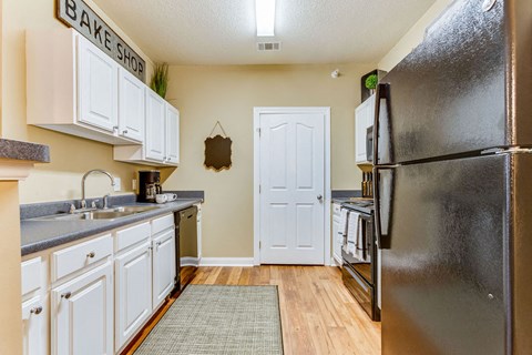 a kitchen with stainless steel appliances and white cabinets
