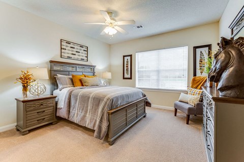 a bedroom with a bed and a horse statue