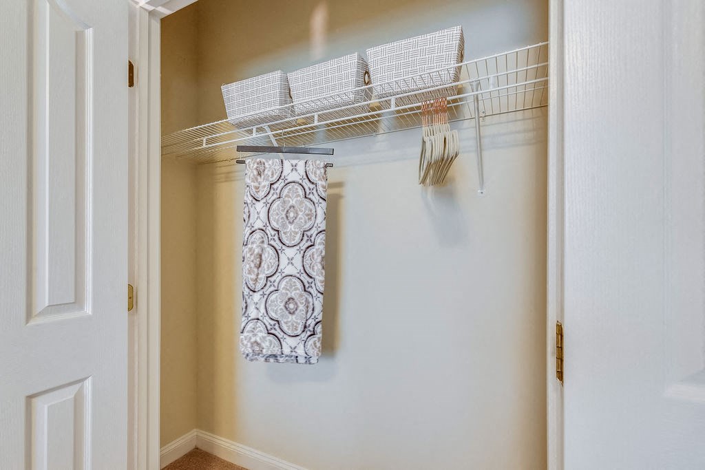 a closet with a towel and a rack on the wall