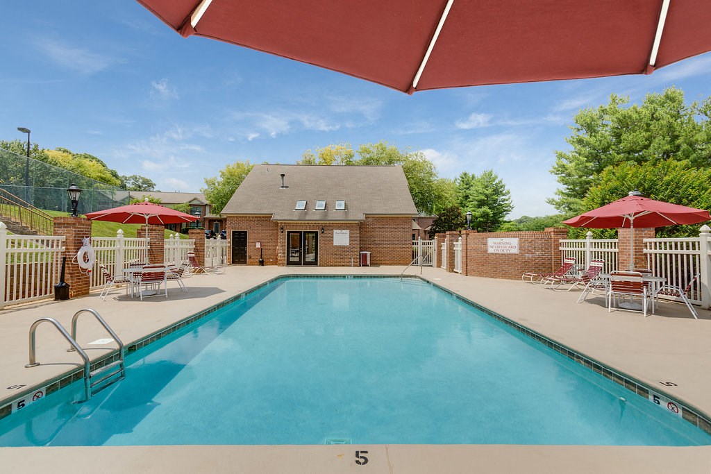 our apartments have a resort style pool with chairs and umbrellas