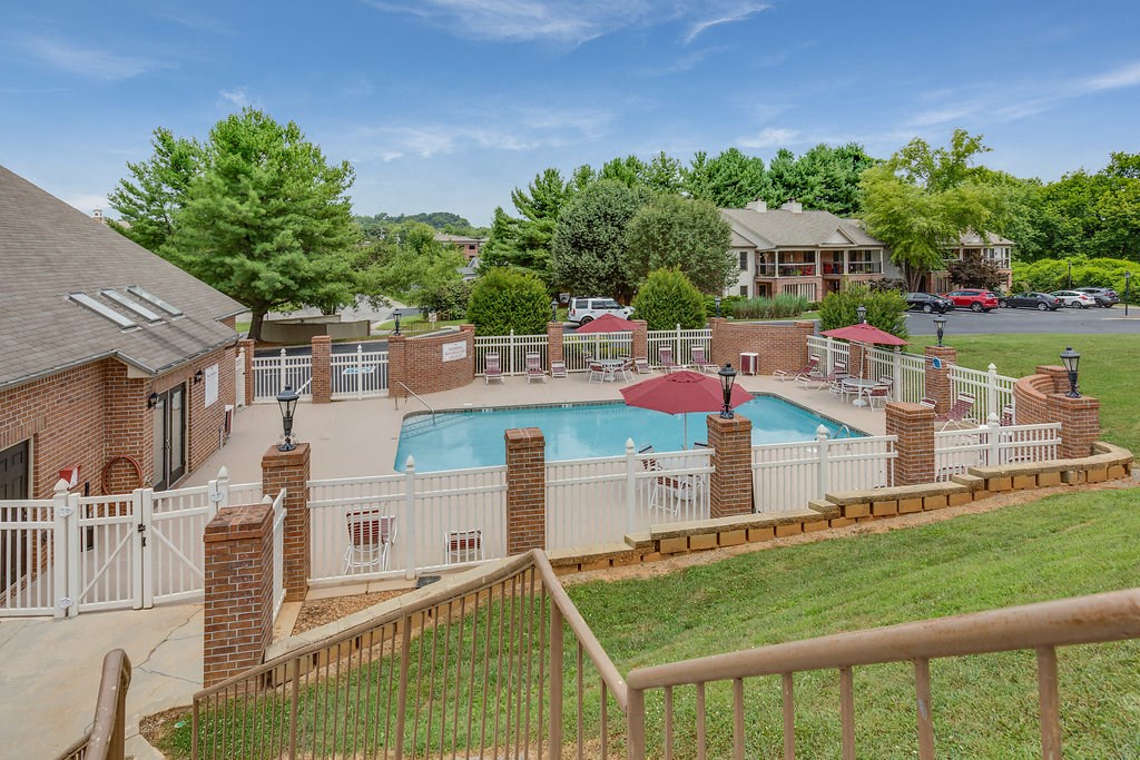a view of a pool with a fence around it