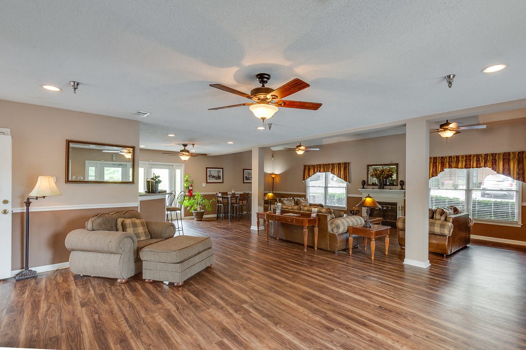 a living room and dining room with a ceiling fan