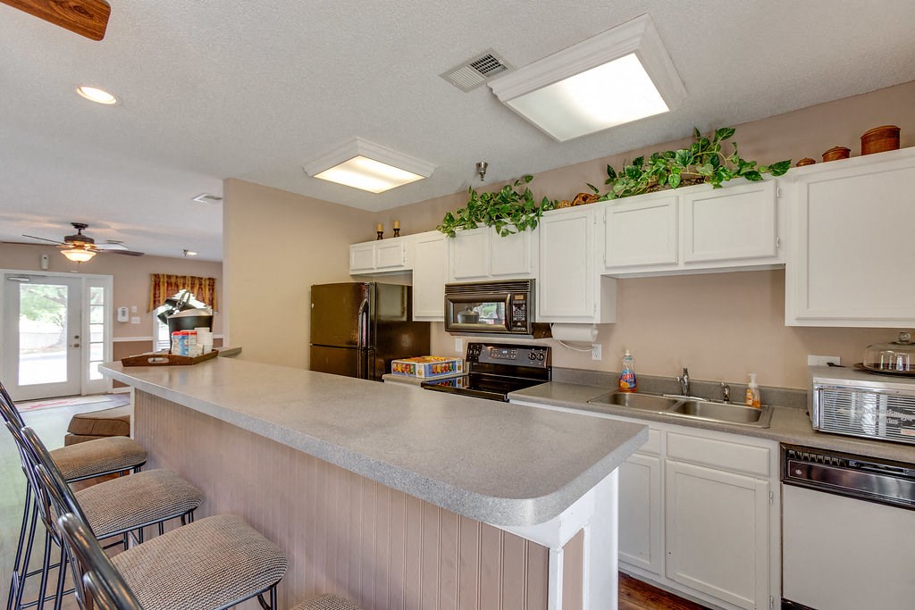 a kitchen with white cabinets and a counter top