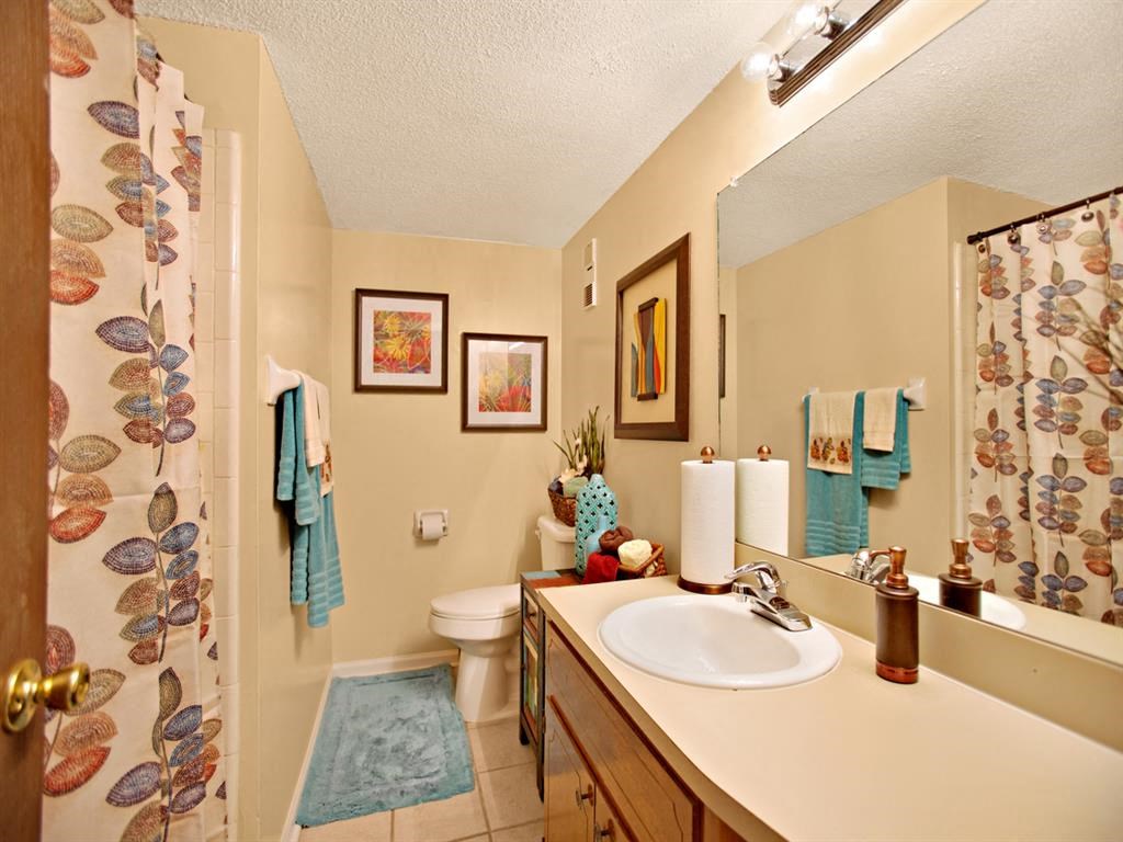 a bathroom with a sink and a shower and a toilet