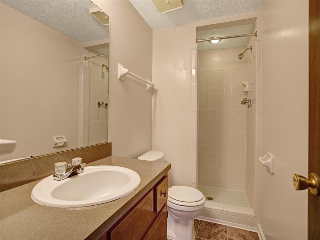 a bathroom with a sink toilet and a shower