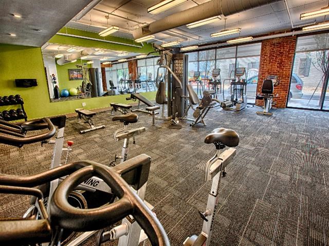 a gym with a large amount of exercise equipment
