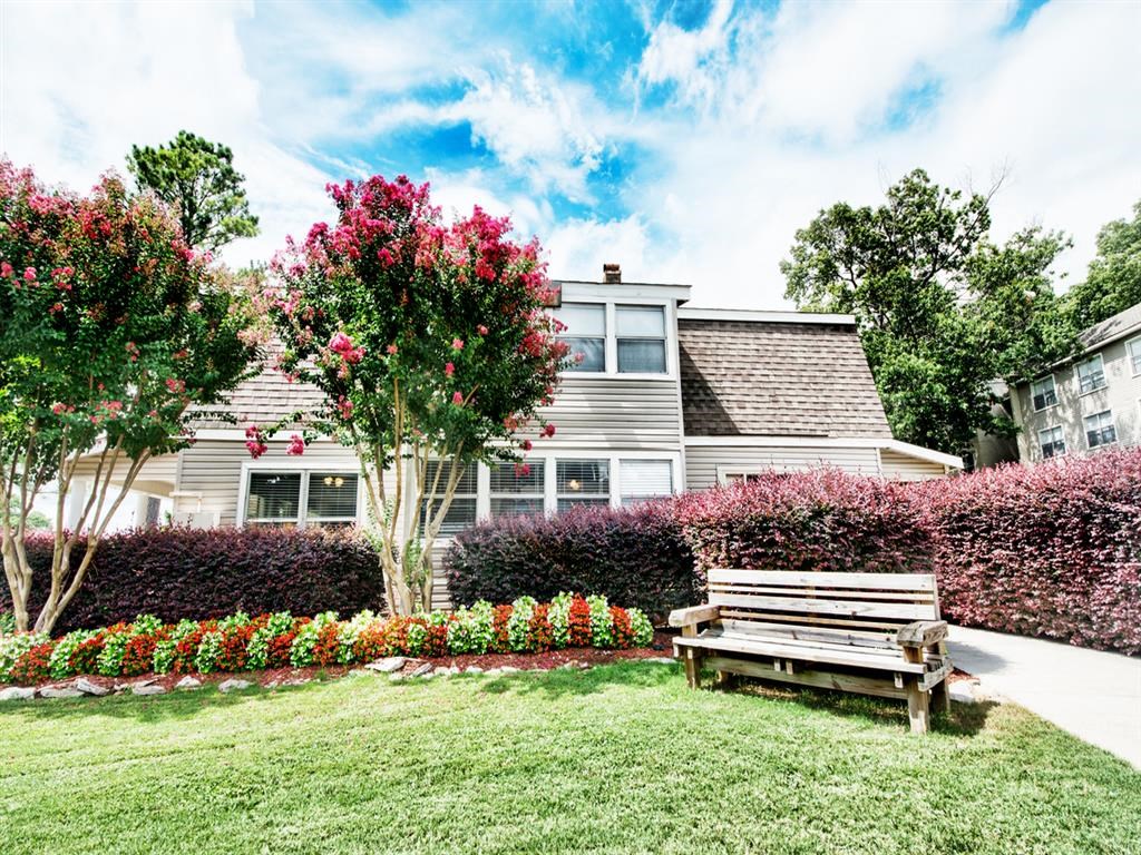 a park bench in front of a house