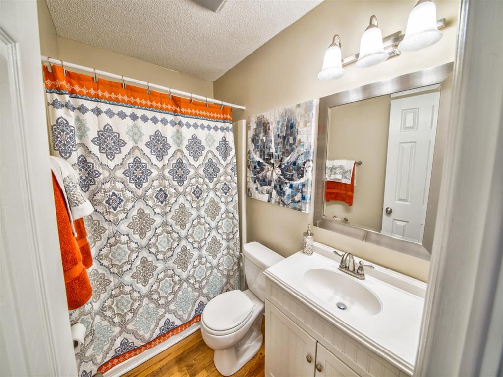 a bathroom with a sink toilet and a mirror