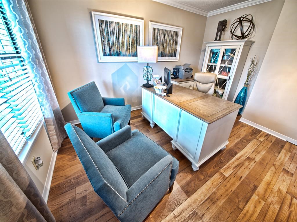 a home office with a desk and two chairs