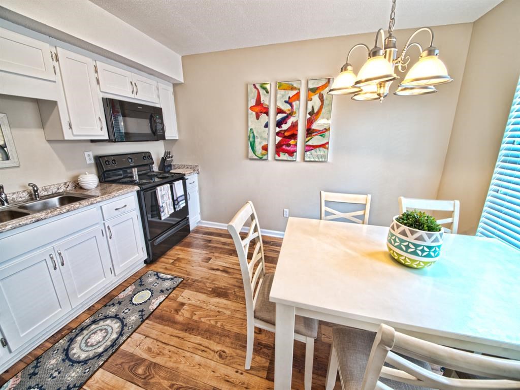 a kitchen and dining room with a table and chairs