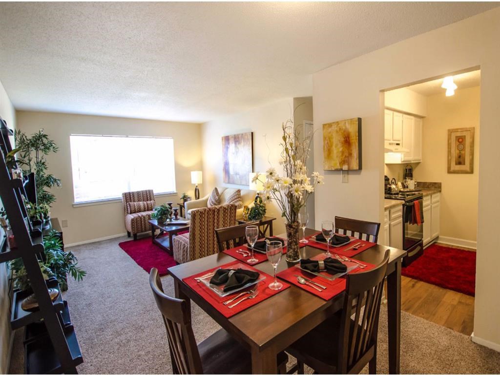 a dining room and living room with a table and chairs