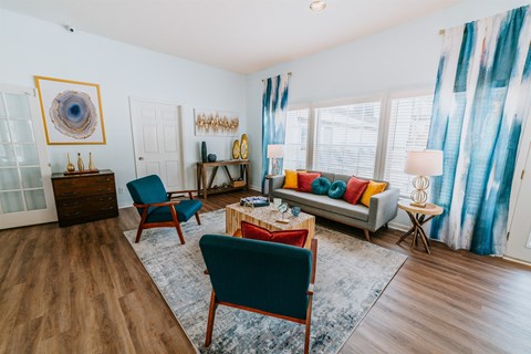 A living room with a blue chair and a red table.