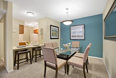 a dining room with a glass table and chairs