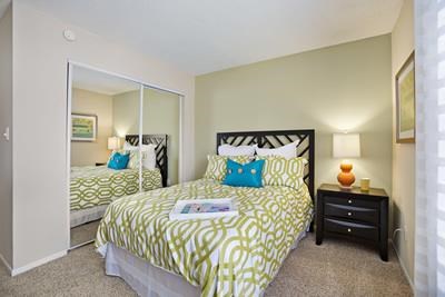 a bedroom with a bed and a mirror