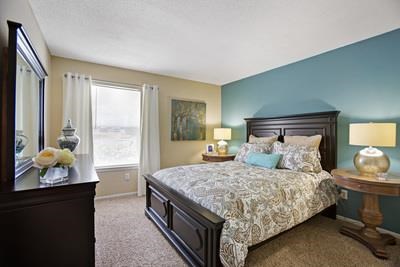 a bedroom with a large bed and a window