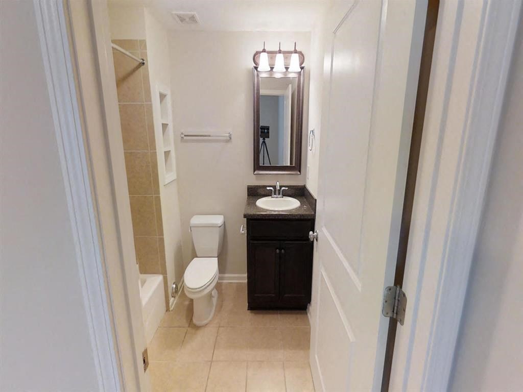 a bathroom with a sink toilet and a mirror