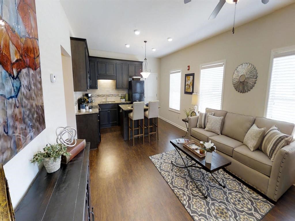 a living room and kitchen with a couch and a table