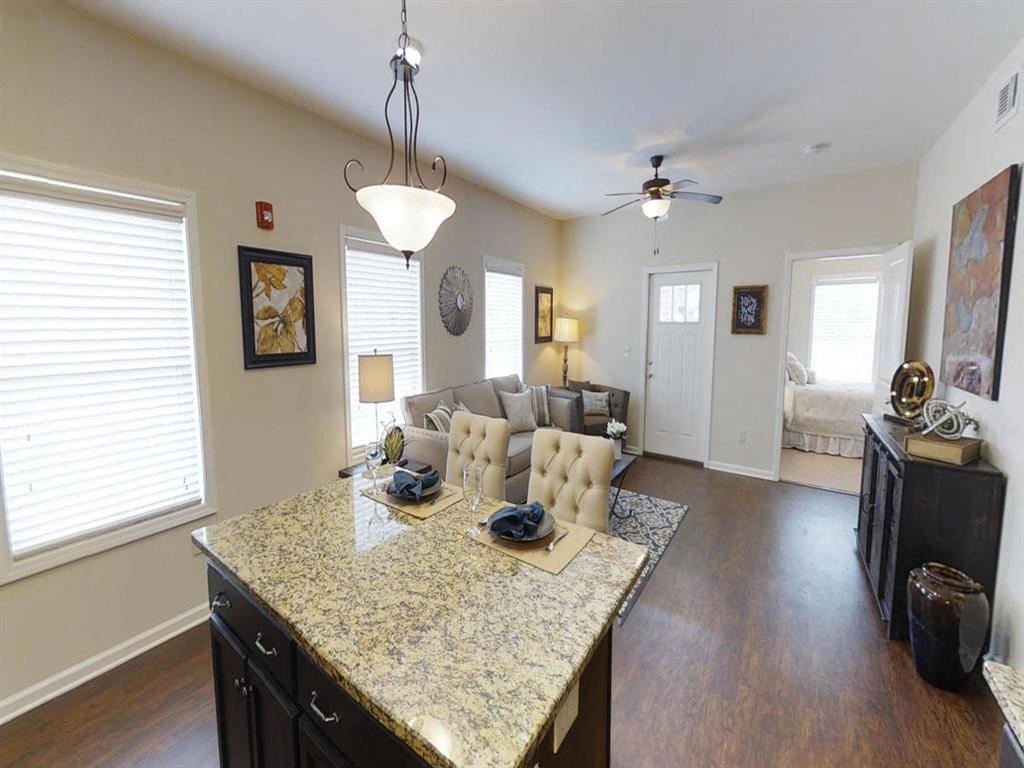 a kitchen and living room with a granite counter top