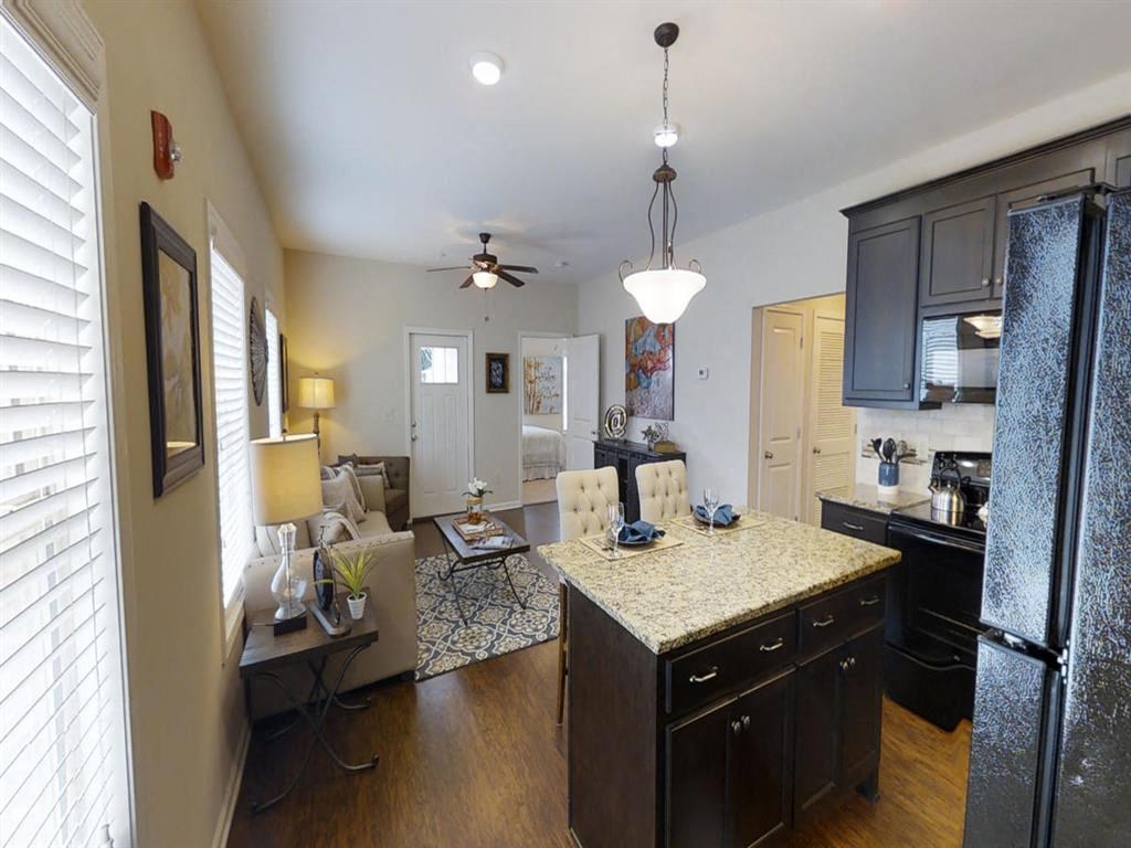 a kitchen and living room with a counter top