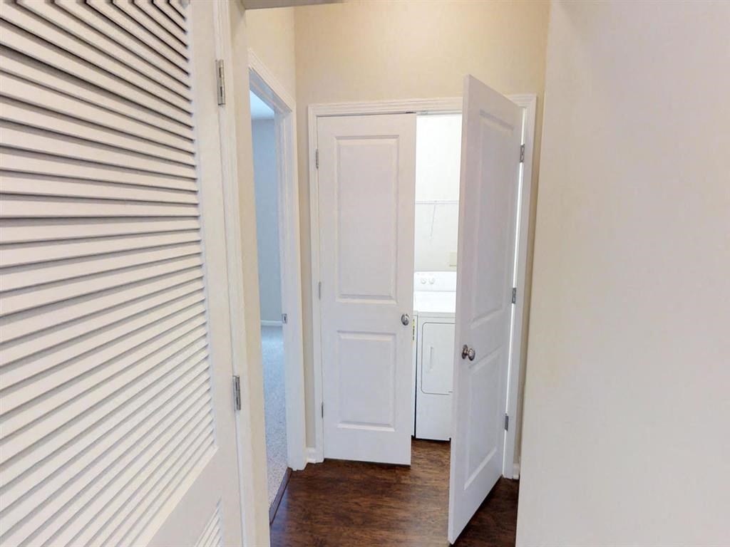 a bedroom with a closet and a door open to a bathroom