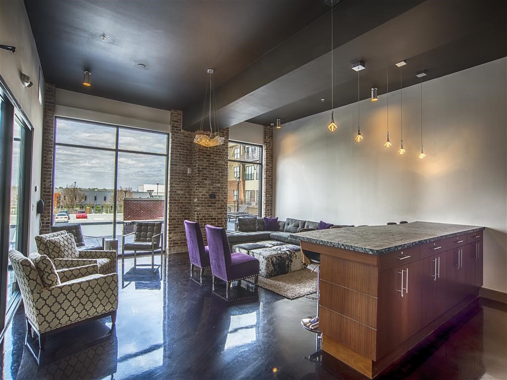 a living room with a bar and a dining room