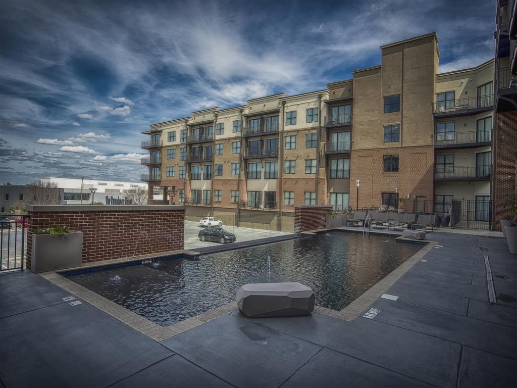 a swimming pool with a building in the background