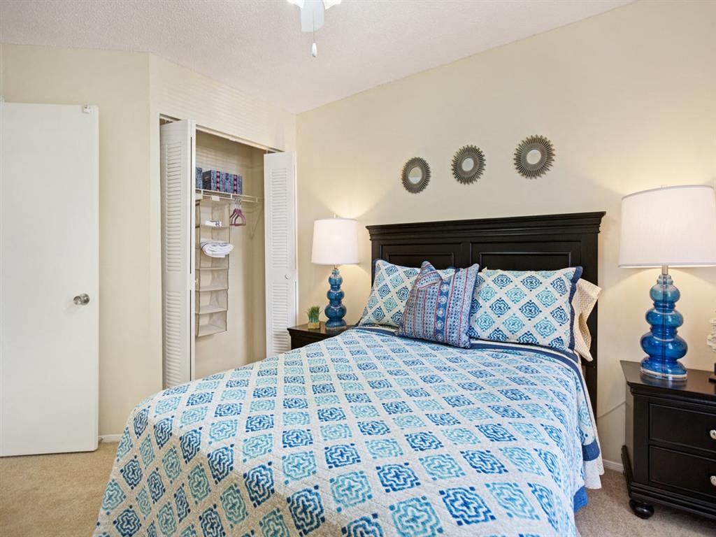 a bedroom with a bed and a closet