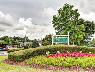 a park with flowers and a sign for stoneberry park