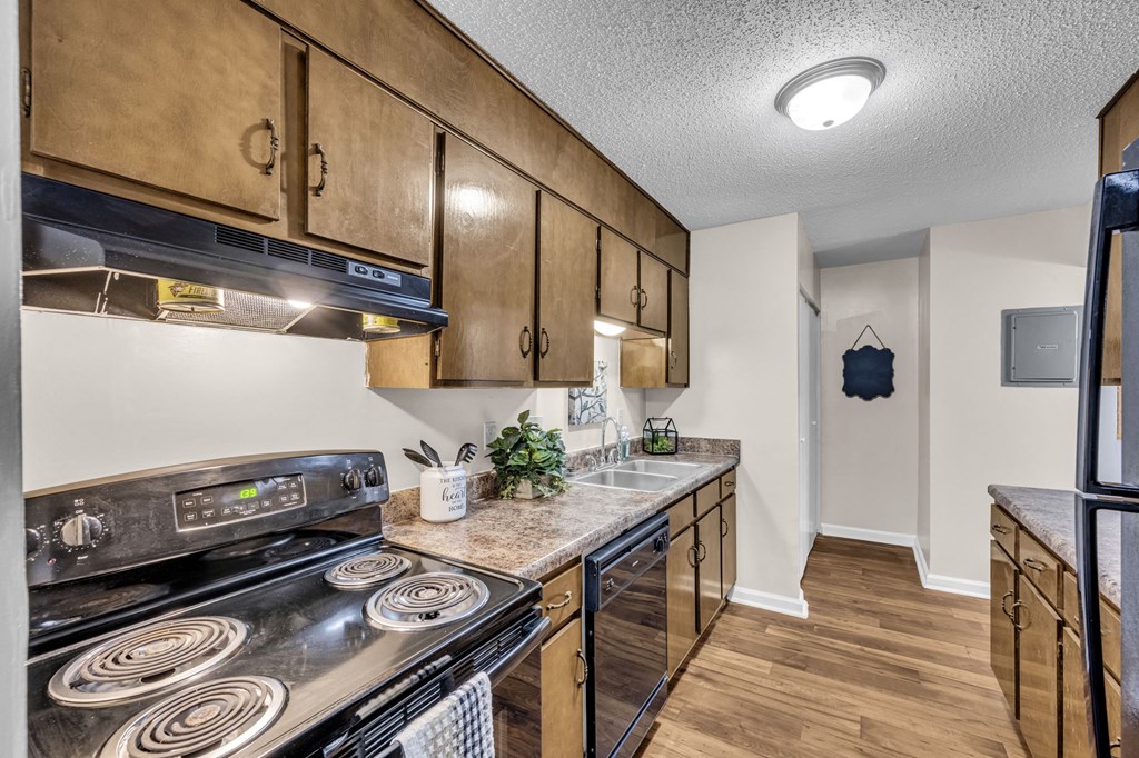 a kitchen with stainless steel appliances and wooden cabinets