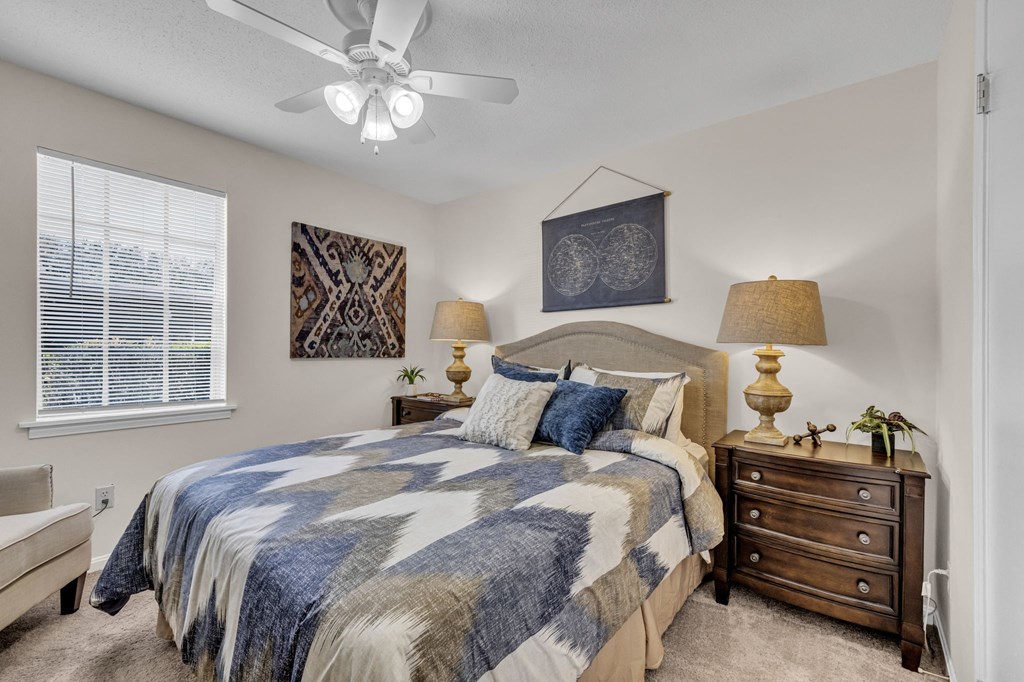 a bedroom with a bed and a ceiling fan