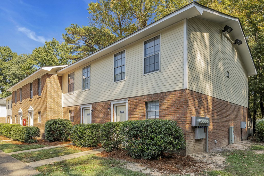 a brick and with bushes and trees