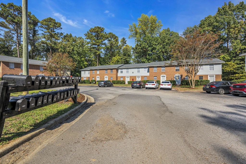 a parking lot with cars in front of a brick building