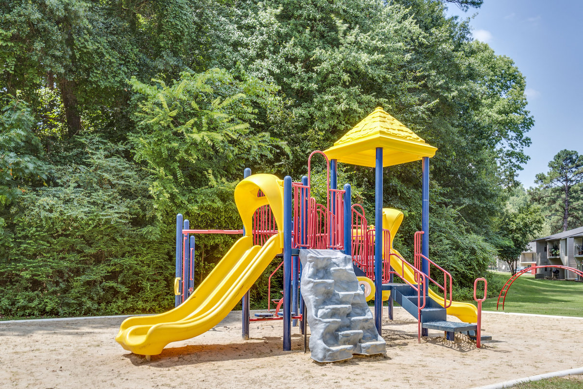 a playground with a yellow and blue slide