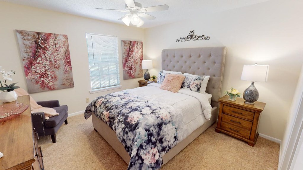 a bedroom with a bed and a ceiling fan