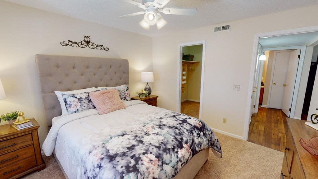a bedroom with a bed and a ceiling fan