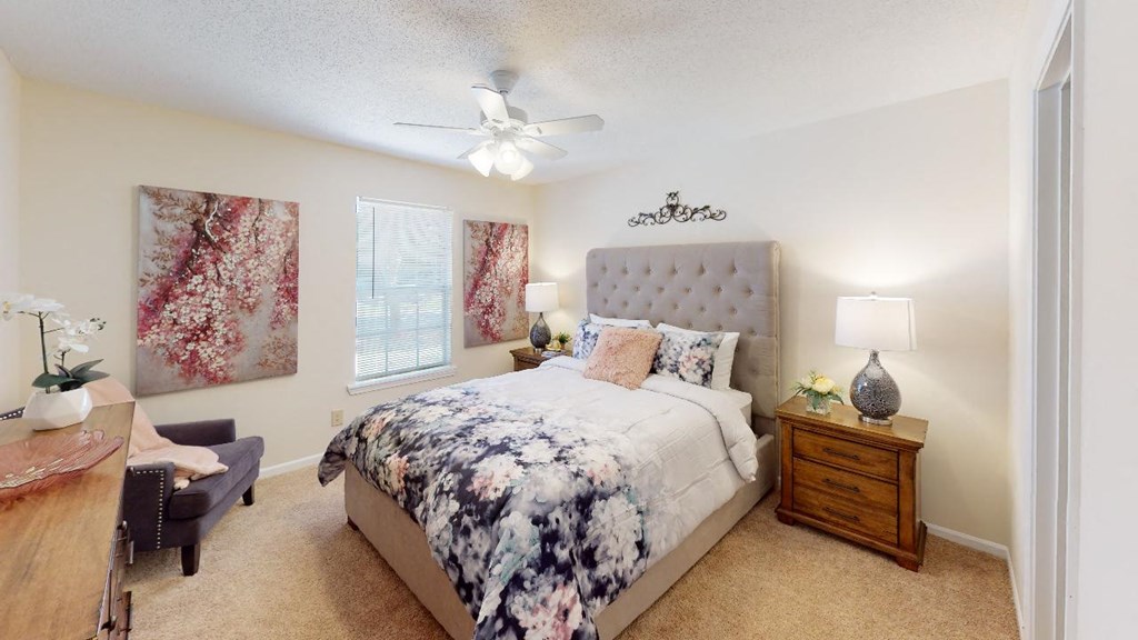 a bedroom with a bed and a ceiling fan